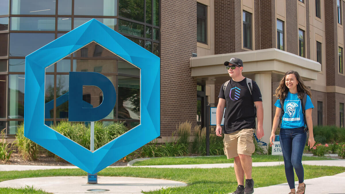 Two people walking in Dakota State University