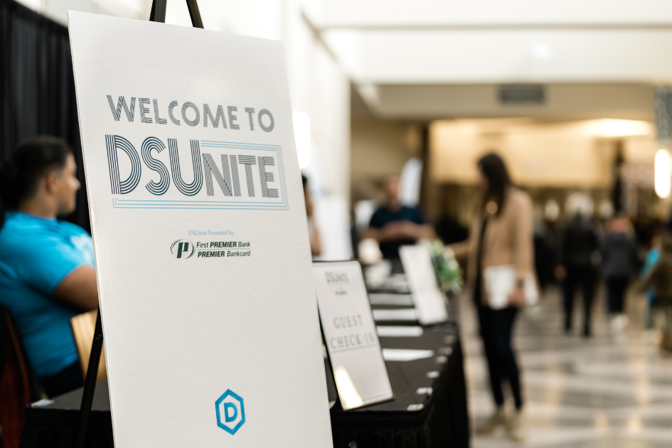 Welcome to DSUnite sign at a check in desk.